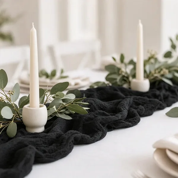 Black cheesecloth table runner styled for a wedding table