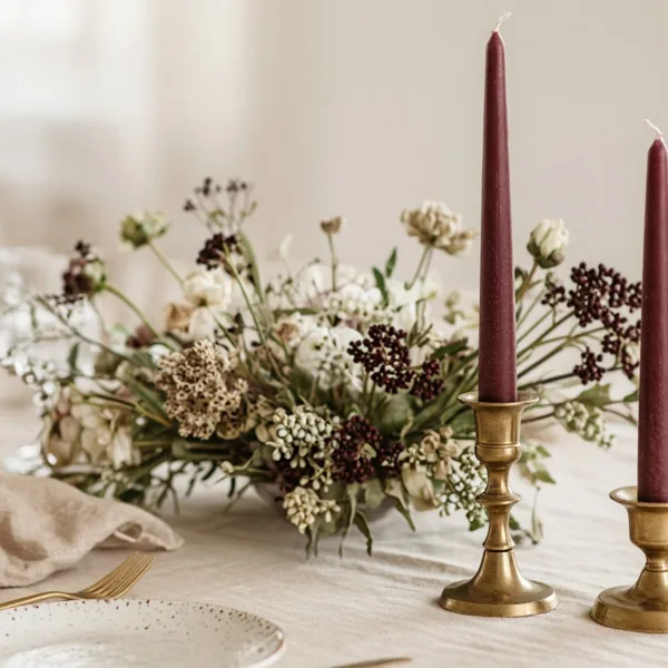 Burgundy taper candles styled for a wedding table