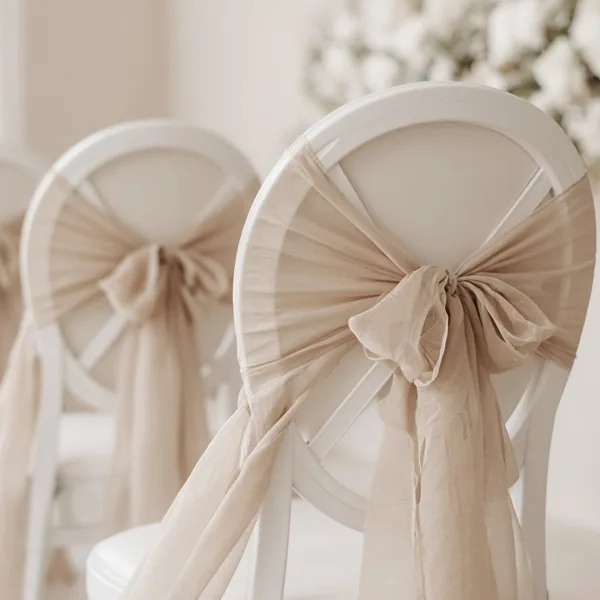 Champagne chair sashes styled for a wedding table