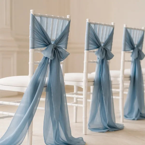 Dusty blue chair sashes styled for a wedding table