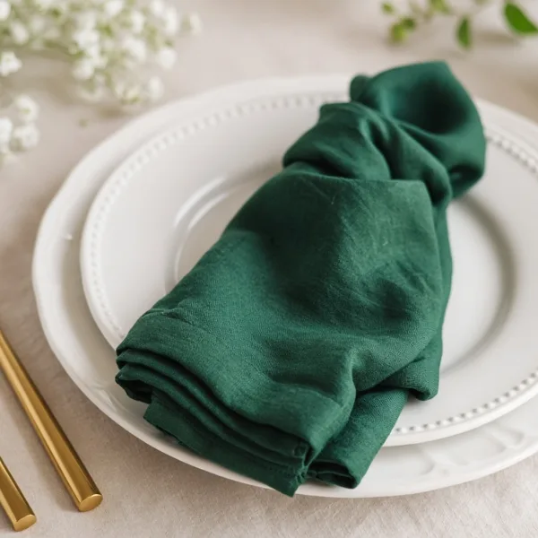 Emerald green cloth napkins styled for a wedding table