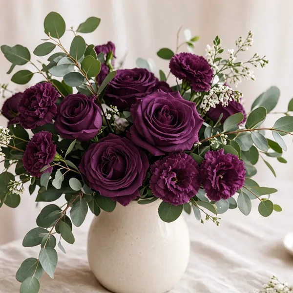 Plum artificial flowers styled for a wedding table