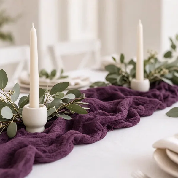 Plum cheesecloth table runner styled for a wedding table
